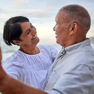 Older couple dancing on the beach