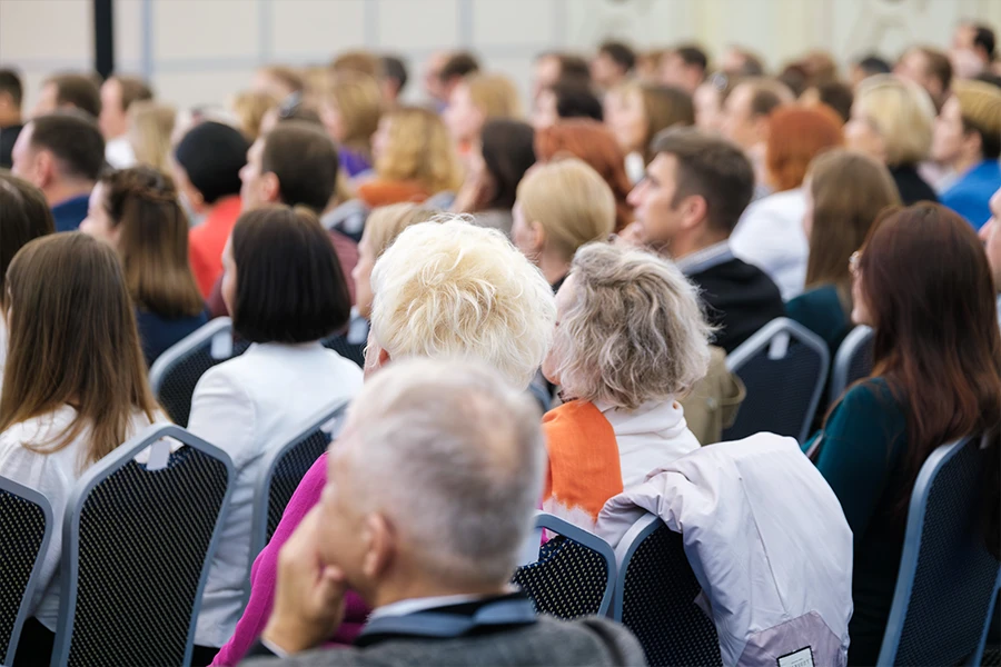 A group of people sitting at a conference